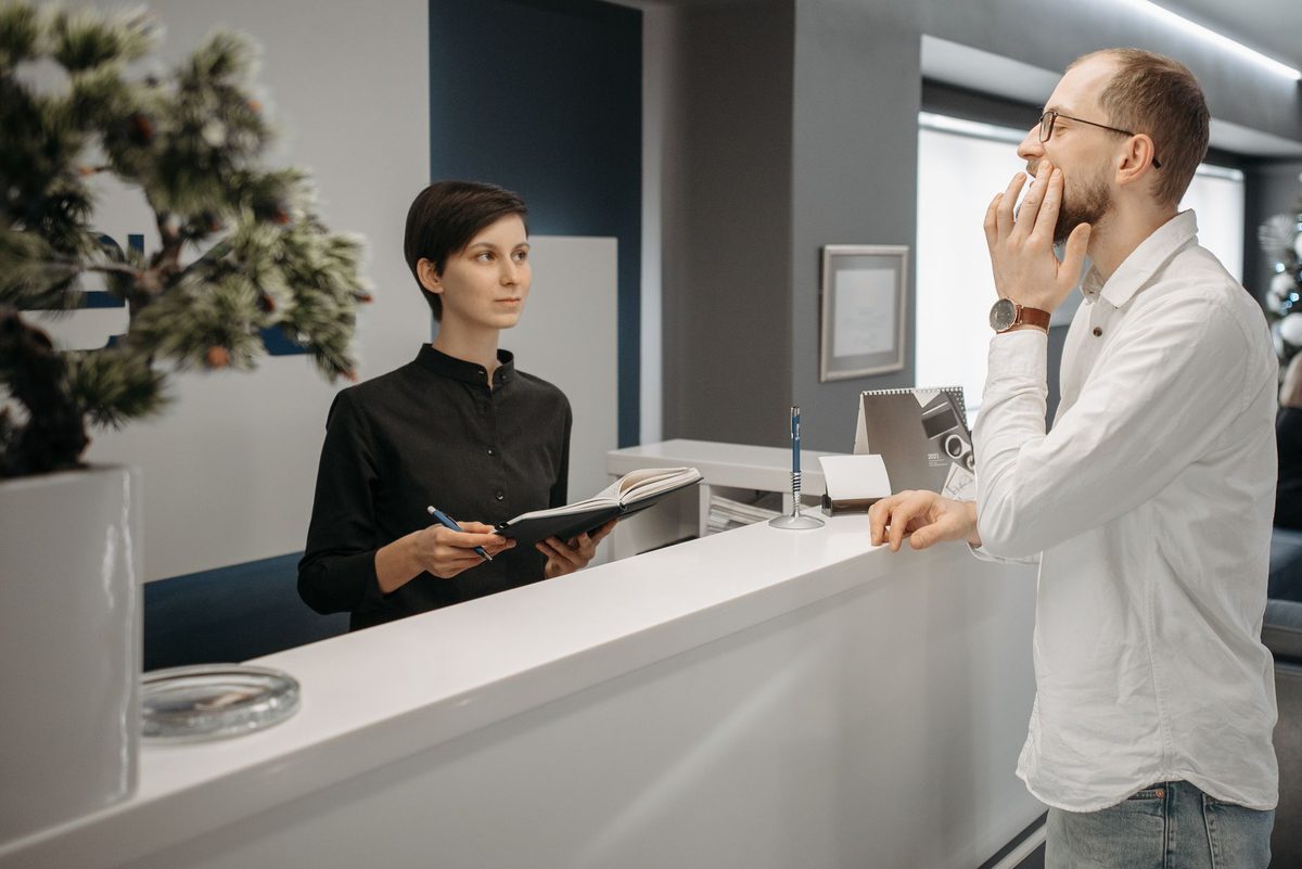 Recepcionista de una clínica atendiendo una llamada para confirmar una cita