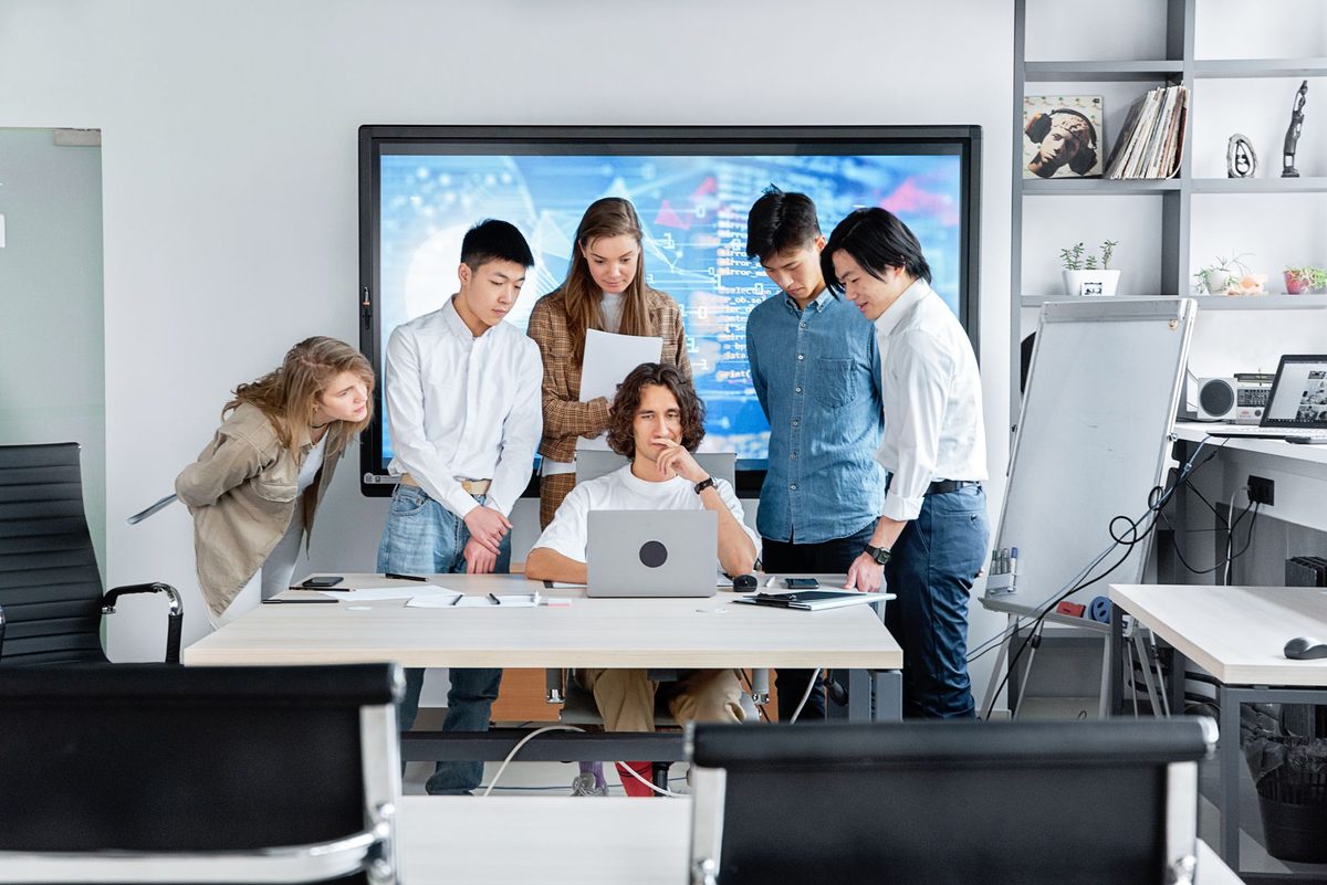 Equipo de una empresa de servicios probando un flujo automatizado en el ordenador de la oficina